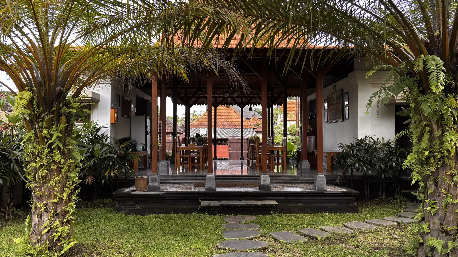Open Balinese pavilion with palm trees at Londo House Ubud